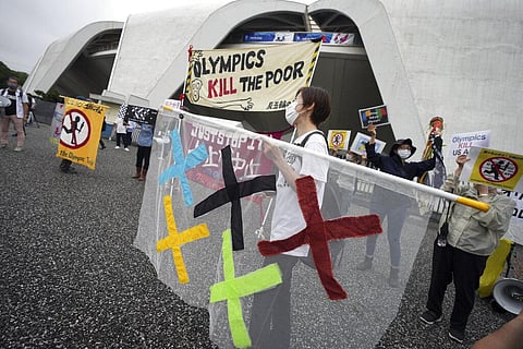 People against Olympic Games protest near Komazawa Olympic Park, where the unveiling ceremony for Olympic Flame of the Tokyo 2020 Olympic torch relay is being held Friday. (Photo | AP)