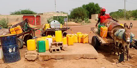 Residents fill up water containers in Dori, Burkina Faso. Fighters linked to al-Qaida and the Islamic State in Burkina Faso have been actively recruiting child soldiers. (Photo | AP)