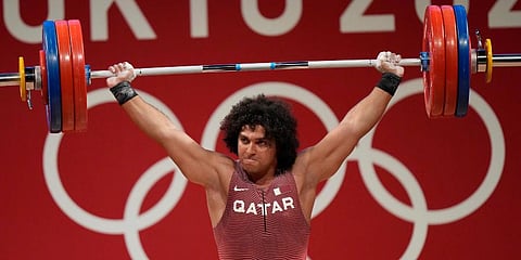 Fares El-Bakh of Qatar competes in the men's 96kg weightlifting event, at the 2020 Summer Olympics in Tokyo, Japan. (Photo | AP)