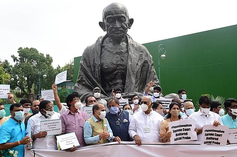 Opposition leaders stage a protest near the Gandhi statue against Pegasus project, during the Monsoon Session of Parliament. (Photo | PTI)