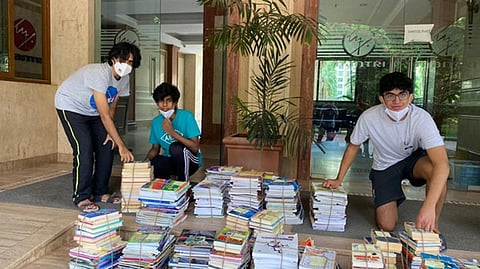 (From left) Praneet Gudladana, Harish Shankar, and Aryan Gupta with the donated books.