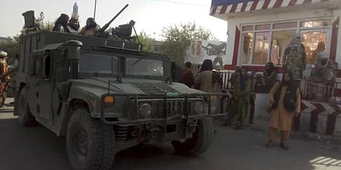 Taliban fighters stand guard at a checkpoint in Kunduz city, northern Afghanistan. (Photo | AP)