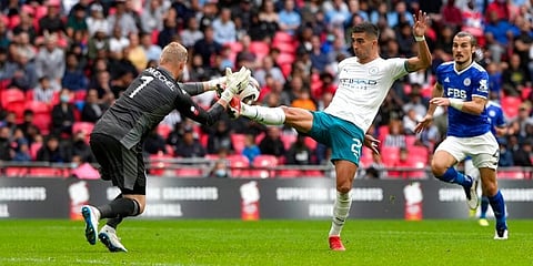 Leicester's goalkeeper Kasper Schmeichel makes a save in front of Manchester City's Ferran Torres. (Photo | AP)