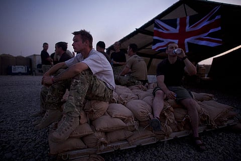 A British soldier of the Royal Corps of Signals, rests after a day spent establishing coms, at Combat Outpost Ouellette, Helmand province in Afghanistan. (Photo | AP)