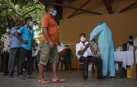 A Sri Lankan military person inoculates a man against COVID-19 at a vaccination center in Colombo. (Photo | AP)