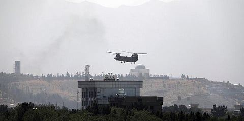 A U.S. Chinook helicopter flies over the U.S. Embassy in Kabul, Afghanistan, Sunday, Aug. 15, 2021. (Photo | AP)