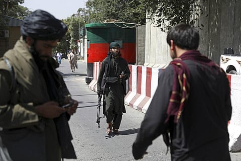 Taliban fighters stand guard at a checkpoint on the road to the Afghan foreign ministry, in Kabul, Afghanistan. (Photo | AP)