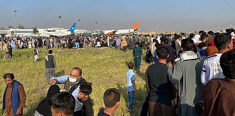 Afghans crowd at the airport as they wait to leave from Kabul on August 16, 2021. (Photo | AFP)