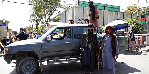 Taliban fighters stand guard in front of main gate leading to Afghan presidential palace, in Kabul, Afghanistan, Monday, Aug. 16, 2021. (Photo | AP)
