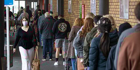Shoppers lineup to enter a supermarket in Auckland, New Zealand. (Photo| AP)