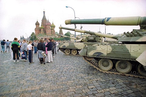 In this photo from August, 1991, groups of people wander among the half dozen Soviet tanks parked behind the Red Square near the bank of the Moscow River. (Photo | AP)