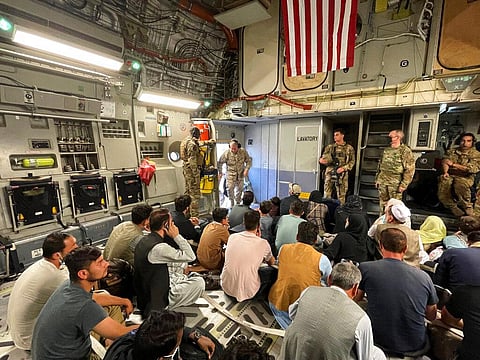 U.S. Marine Corps Gen. Frank McKenzie, the commander of U.S. Central Command, enters a plane evacuating people, at Hamid Karzai International Airport. (Photo | AP)