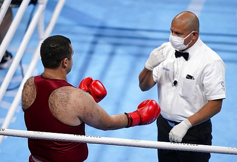 Referee checks S. Zukhurov of Tajikistan before the start of match against M. Aliev of France in men's super-heavy weight 91 kg preliminaries round Boxing match. (Photo | AP)