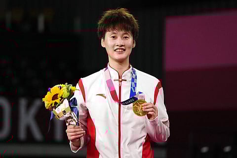 Gold medalist China's Chen Yu Fei shows her medal during the medals ceremony for women's singles Badminton match at the 2020 Summer Olympics. (Photo | AP)