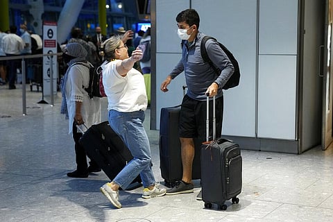 Karen Tyler runs to hug her son Jonathan, who she's not seen for over a year and a half as he arrives on a flight from the U.S., at Heathrow Airport in London. (Photo | AP)