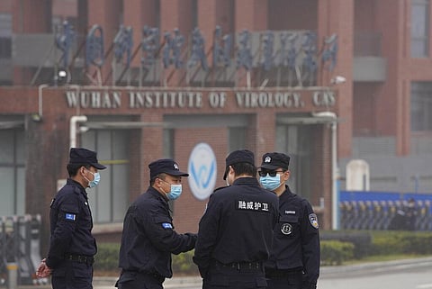 Security personnel gather near the entrance of the Wuhan Institute of Virology during a visit by the World Health Organization team. (File Photo | AP)