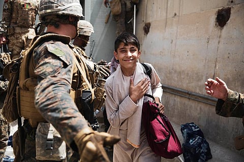 A boy is processed through an Evacuee Control Checkpoint during an evacuation at Hamid Karzai International Airport, in Kabul. (Photo | AP)
