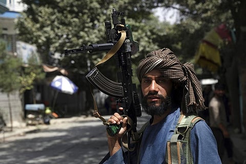 A Taliban fighter stands guard at a checkpoint in the Wazir Akbar Khan neighborhood in the city of Kabul. (Photo | AP)