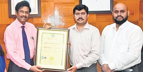 AMC principal PV Sudhakar receiving ISO certification from district collector. (Photo | Express)