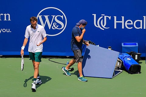 Daniil Medvedev reacts after colliding with a courtside television camera, in his match against Andrey Rublev during the Western & Southern Open. (Photo | AP)