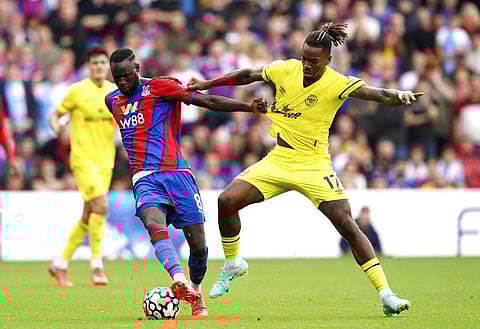 Crystal Palace's Cheikhou Kouyate, left, and Brentford's Ivan Toney battle for the ball during the English Premier League soccer match. (Photo | AP)