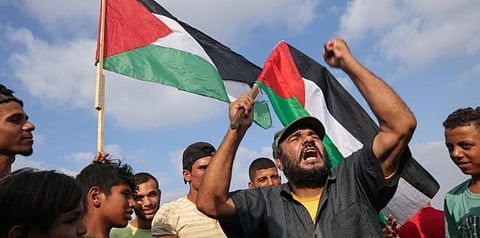 Palestinian protesters react during a demonstration by the border fence with Israel, east of Gaza City, to denounce the Israeli siege of the Palestinian strip. (Photo | AFP)