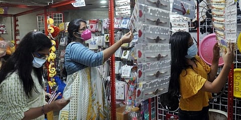 Mask wearing women at a store. (Photo | EPS)