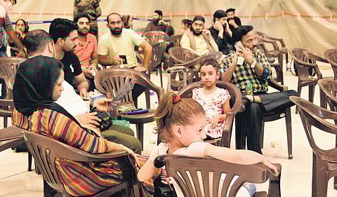 People evacuated from Afghanistan rest after landing at Hindon air base on Sunday. (Photo | EPS)