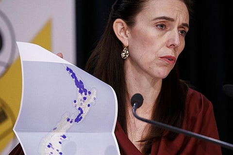 New Zealand Prime Minister Jacinda Ardern holds a map of New Zealand during a COVID-19 update press conference in Wellington. (Photo | AP)
