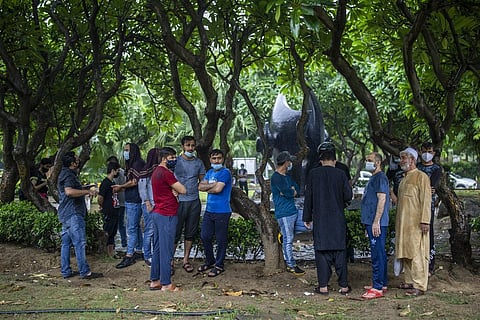 Afghan refugees living in India wait outside Australian embassy hoping to get humanitarian visa in New Delhi, India on Aug. 20, 2021. (Photo | AP)