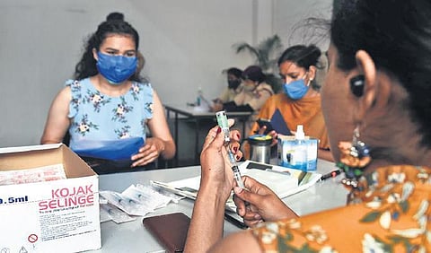 A healthcare worker prepares a dose of Covid vaccine. (Photo | Parveen Negi, EPS)