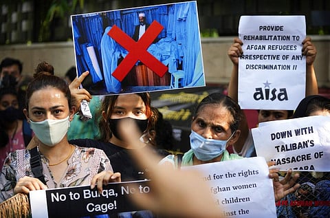 Human right activists with Afghans living in India hold banners and shout slogans during a protest against the Taliban takeover of Afghanistan. (Photo | AP)