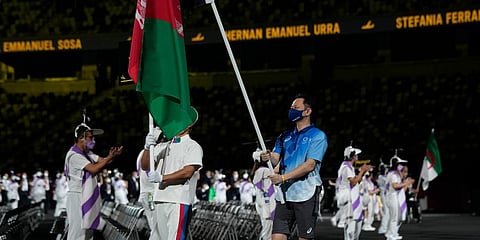 A flag bearer carries the Afghanistan flag into the stadium during the opening ceremony for the 2020 Paralympics at the National Stadium in Tokyo. (Photo | AP)