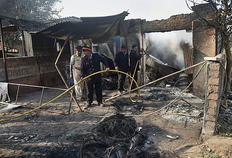 Fire men at a charred shop following the violence during celebrations of 200th anniversary of the Battle of Bhima Koregaon, near Pune. (File Photo | PTI)