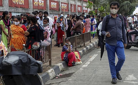 People line up to get inoculated against COVID-19 outside a vaccination center in Mumbai. (Photo | AP)