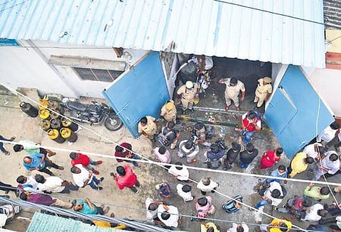 Passersby and police personnel at the snacks unit, soon after the boiler explosion | Express