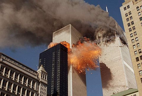 In this file picture from the September 11, 2001 attacks, smoke billows from the north tower of the World Trade Center in New York as flames and debris explode from the south tower. (Photo | AP)