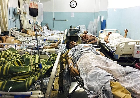Wounded Afghans lie on a bed at a hospital after a deadly explosion outside the airport in Kabul, Afghanistan. (Photo | AP)