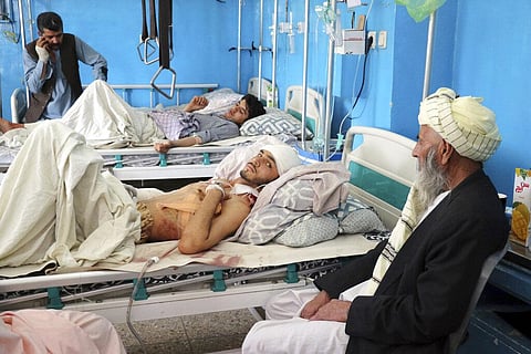Afghans lie on beds at a hospital after they were wounded in the deadly attacks outside the airport in Kabul. (Photo | AP)
