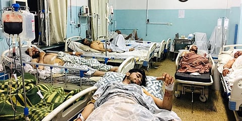Afghans lie on beds at a hospital after they were wounded in the deadly attacks outside the airport in Kabul. (Photo | AP)