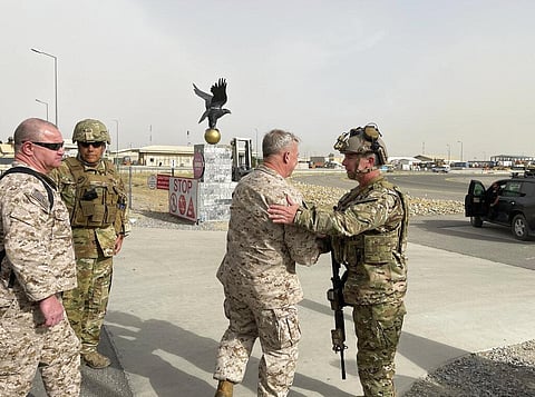 U.S. Marine Corps Gen. Frank McKenzie, center, meets with U.S. Navy Rear Adm. Peter Vasely, commander of U.S. Forces Afghanistan-Forward, at Kabul Airport. (File Photo | AP)