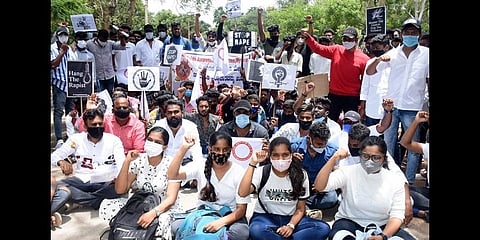 Students protest demanding that the state government arrest the accused involved in the recent gang-rape of a college student, in Mysuru on Friday | Udayshankar S