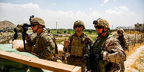 US Marine Corps and German military survey an entry gate at Hamid Karzai International Airport in Kabul. (Photo | AP)