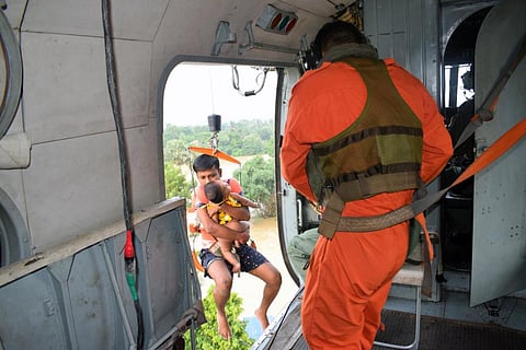 Indian Air Force(IAF) helicopters rescue people from the rooftops in the flood-affected areas of Khanakul, in Hooghly on Sunday. (Photo | ANI)