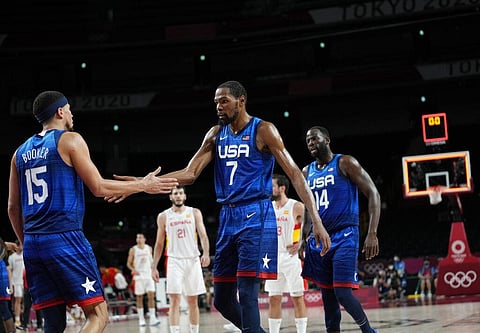 United States' Kevin Durant (7), center, and teammates celebrate their win in the men's basketball quarterfinal game against Spain. (Photo | AP)