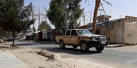Afghan security personnel patrol a deserted street during fighting between Taliban and Afghan security forces, in Lashkar Gah in southern Afghanistan. (Photo| AP)