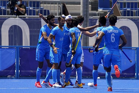 India's Mandeep Singh, second from left, celebrates with his teammates after scoring during a men's field hockey semi-final match against Belgium. (Photo | AP)