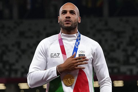 Lamont Marcell Jacobs, of Italy stands on the podium with his gold medal following the men's 100-meters final. (Photo | AP)
