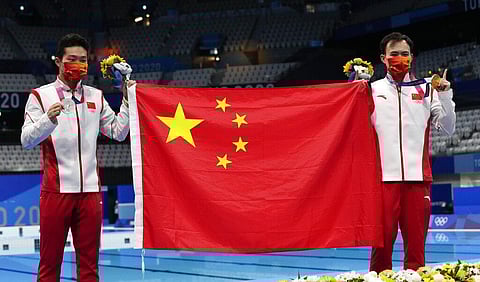 Wang Zongyuan of China, left, silver medal and Xie Siyi of China gold medal pose for a photo after men's diving 3m springboard final. (Photo | AP)