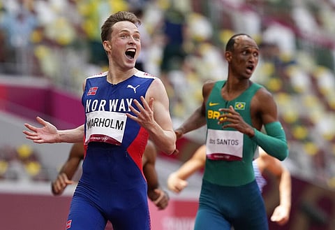 Karsten Warholm, of Norway celebrates as he wins the gold medal in the final of the men's 400-meter hurdles at the 2020 Summer Olympics. (Photo | AP)